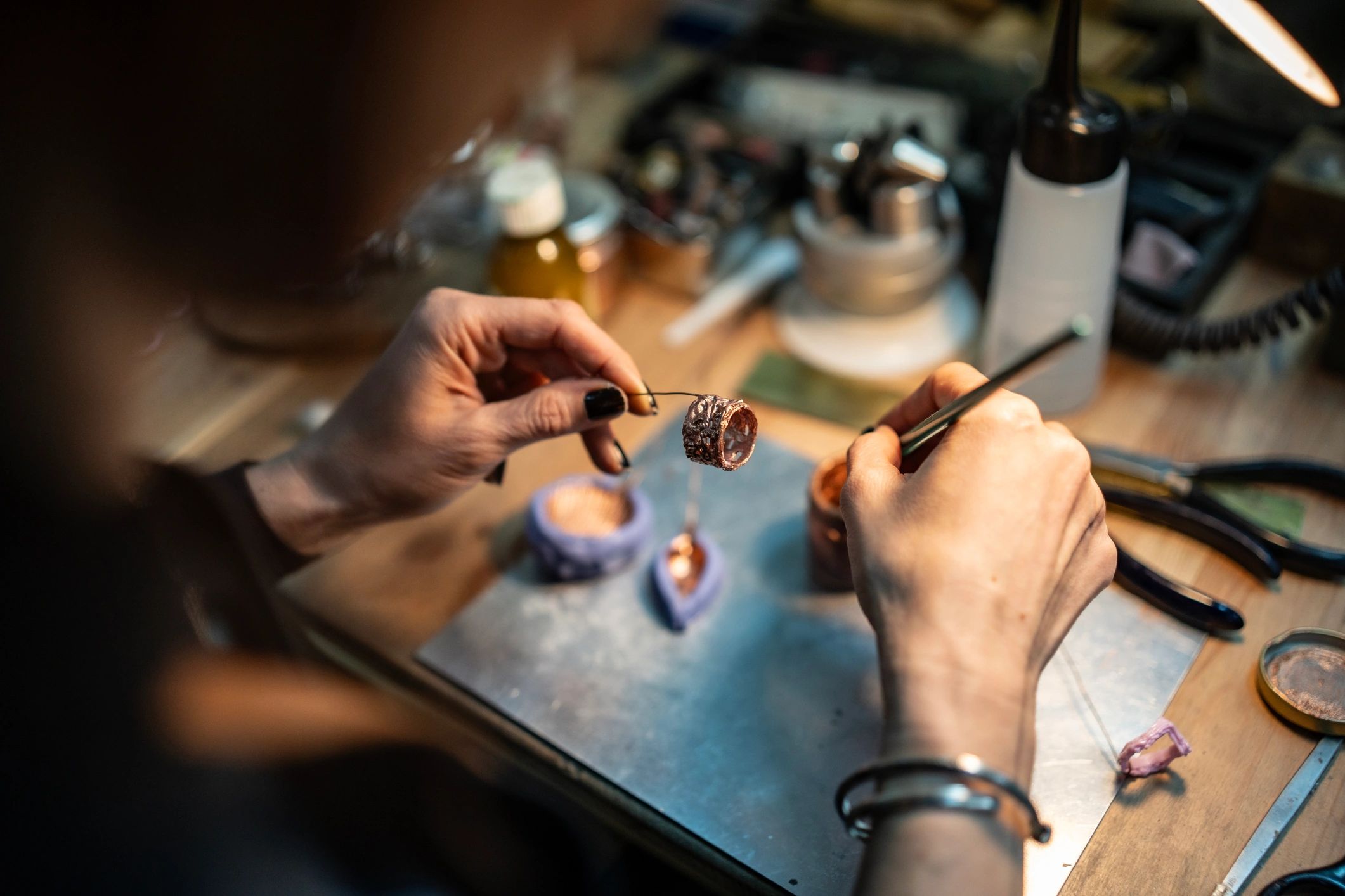 Jewelry artisan working carefully with tools by hand