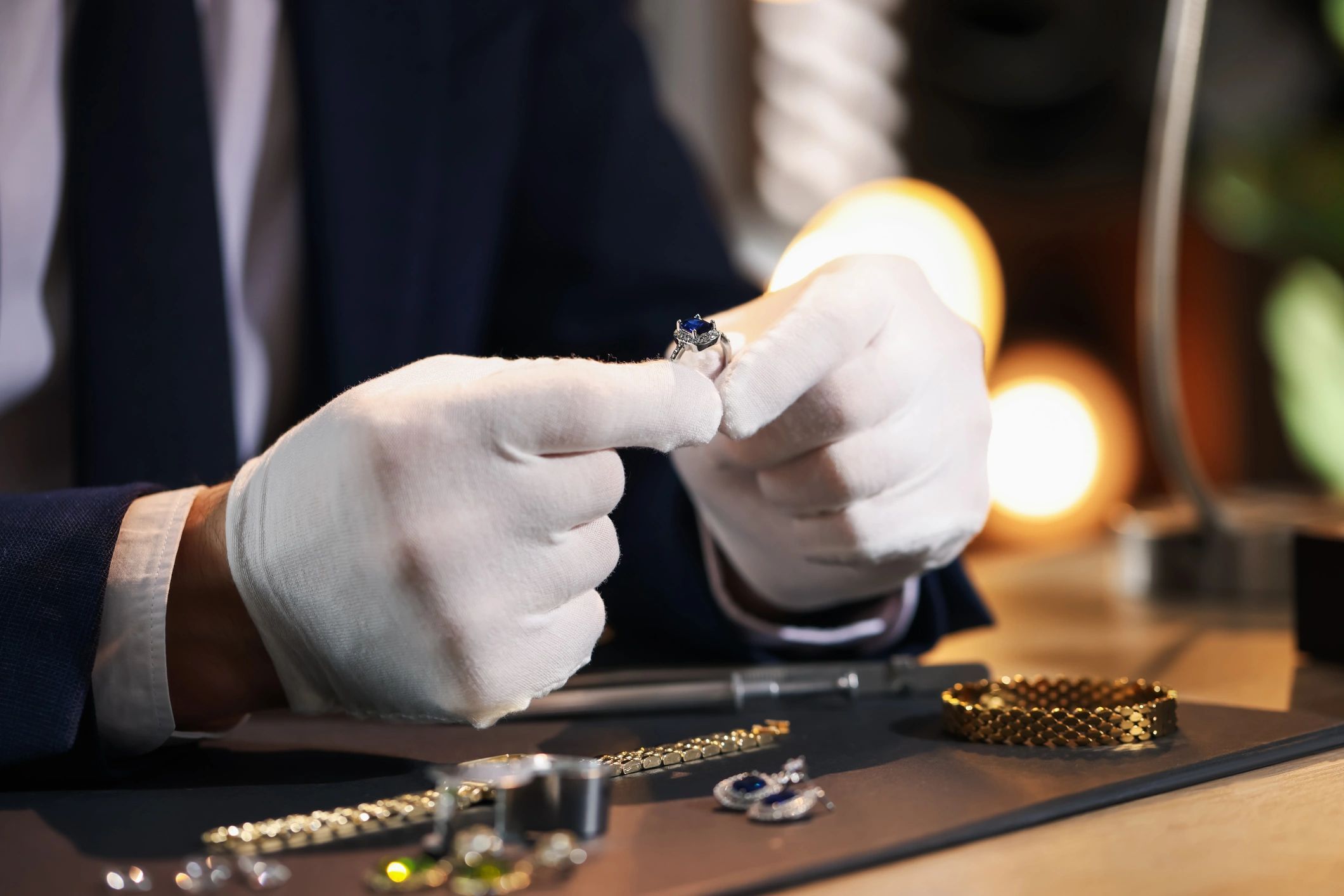 Close-up of hands examining a crafted ring